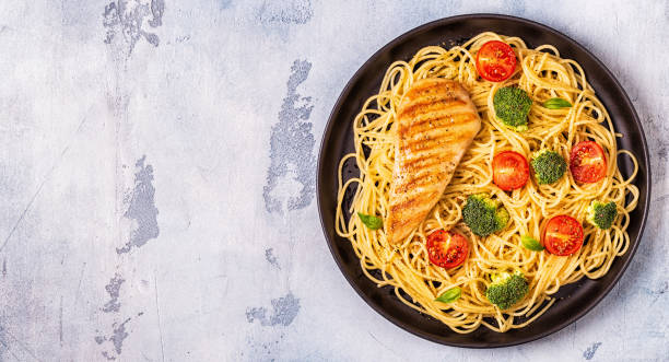 istock Plate of spaghetti tomato broccoli chicken 1077554190