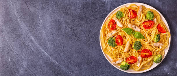 istock Plate of spaghetti tomato broccoli chicken 1077554370