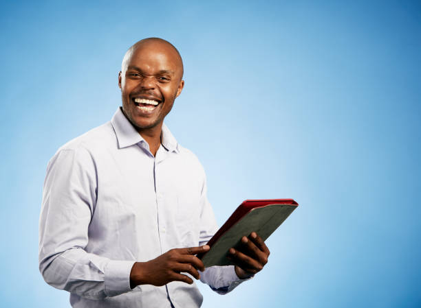 istock Smiling black businessman holding digital tablet 1077555232