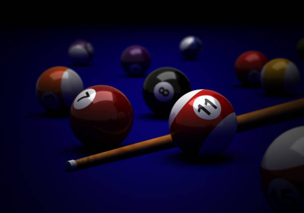 Billiard balls and cue on blue background