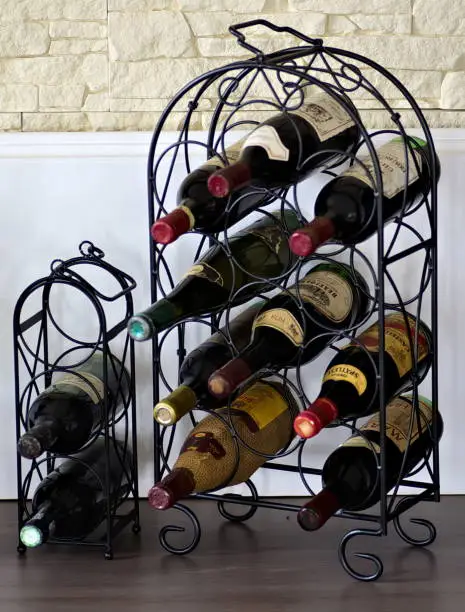 A metal storage case with a few wine bottles placed on it.