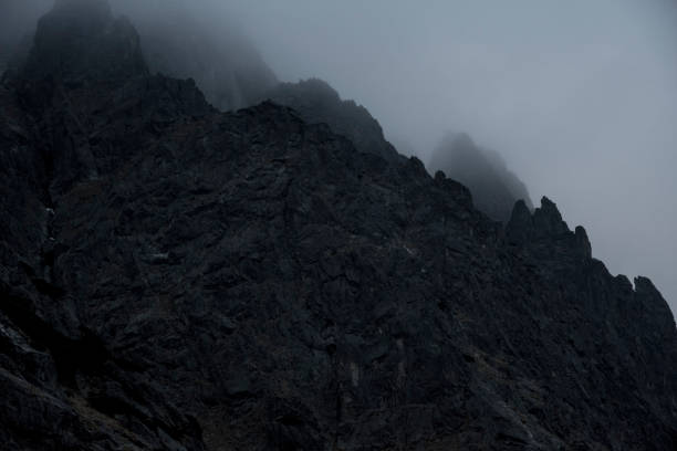 dark mountain peak in the fog