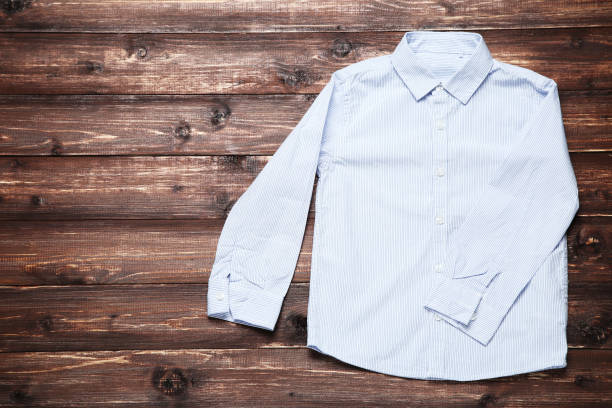 istock Blue shirt on brown wooden table 1077559250
