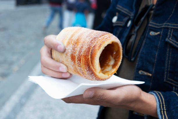 istock man eating a typical Czech trdelnik in Prague 1077560870