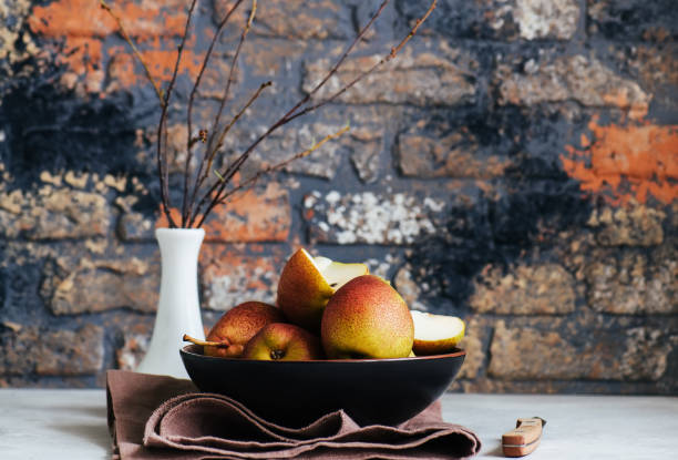 istock Group of whole and sliced pears in a plate 1077563628