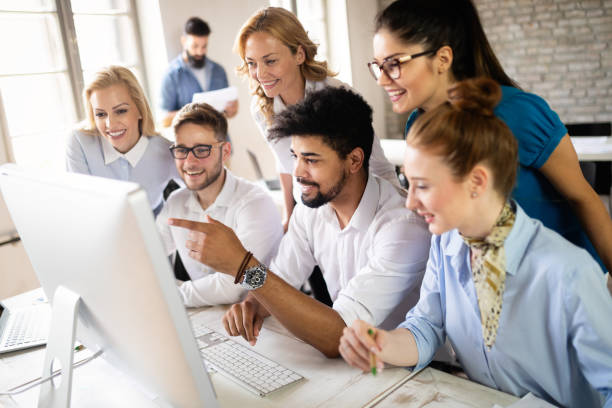 istock Successful happy group of people learning software engineering and business during presentation 1077565530