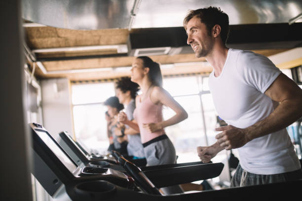 istock People running on treadmill in gym doing cardio workout 1077567696