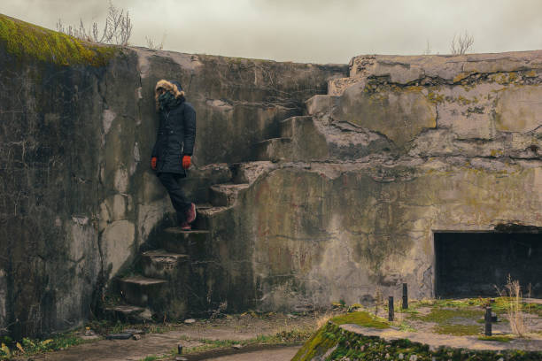 istock young woman stands on the stairs 1077569268