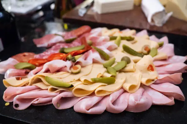 Assortment of tasty and delicious Italian antipasto platter. Chorizo, Salami sausage, Bologna and deli meats with cheese and pickles. A perfect appetizer, party snack, or good accompany with wine