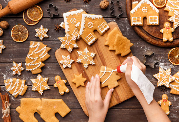 istock Woman decorating homemade cookies with royal icing on table 1077576868
