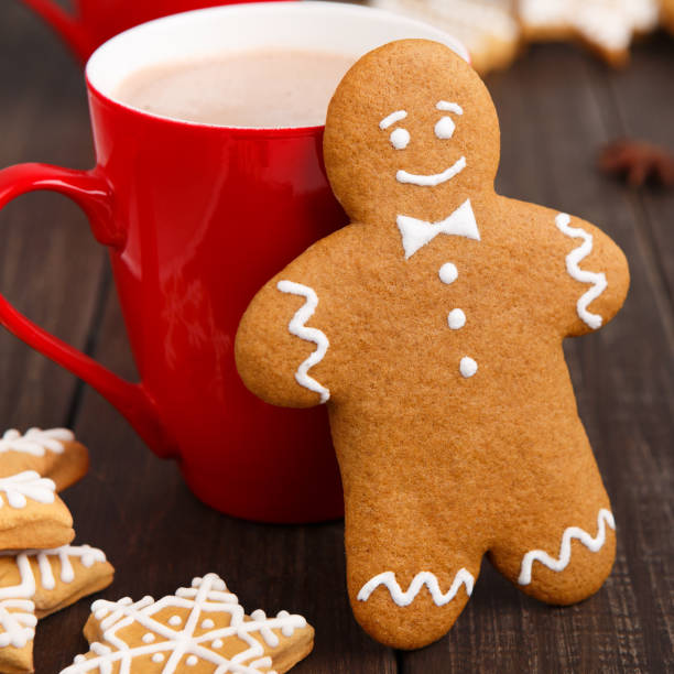 istock Gingerbread man leaning against red cup with cocoa 1077576898