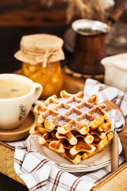 istock Breakfast with belgian waffles, jam and coffee on tray 1077580778