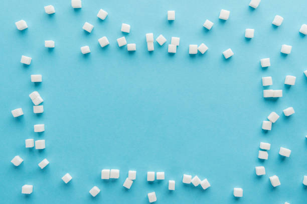 istock top view of frame made with sugar cubes and copy space on blue background 1077583732