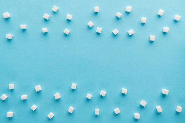 istock top view of white sugar cubes with copy space on blue background 1077583774