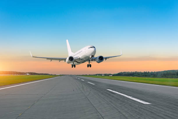 Passenger plane fly up over take off runway from airport at sunset. Passenger plane fly up over take off runway from airport at sunset airplane landing stock pictures, royalty-free photos & images