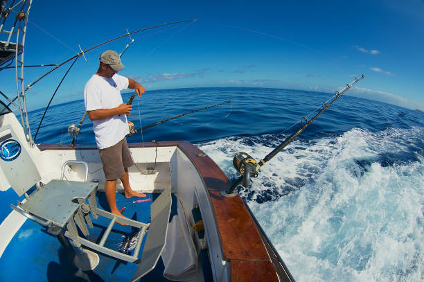 Sailor Gets Ready Reels And Rods For Marlin Game Fishing At Sea Near  Saintdenis Reunion Island Stock Photo - Download Image Now - iStock