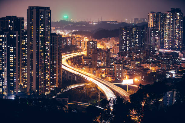 istock Moving car with blur light through city at night 1077584560