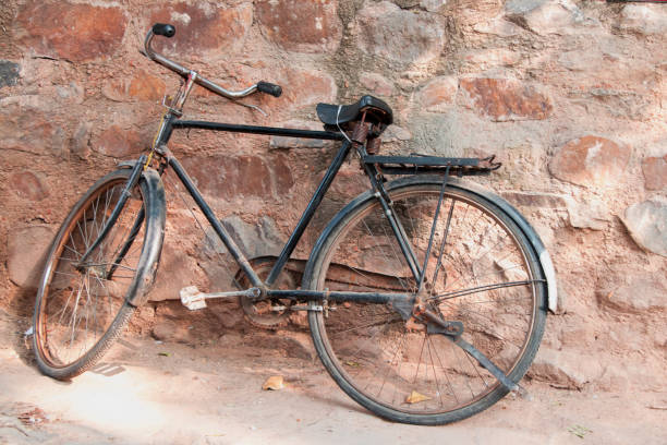 istock image of bicycle resting on stone wall 1077588324
