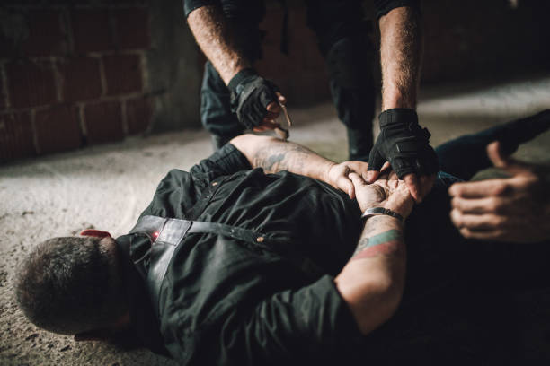 istock Putting handcuffs on a gangster 1077590688