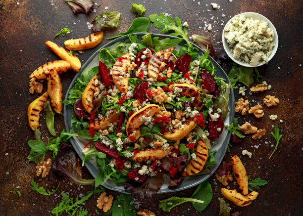istock Grilled quince salad with baked and fresh grated beetroot, blue cheese, walnuts on rustic table 1077595764