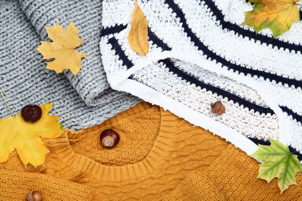 istock Knitted sweaters with chestnuts, acorns and autumn leafs 1077598906