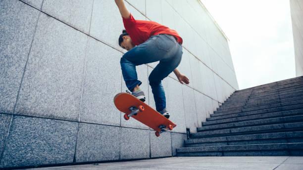 istock Skateboarder doing ollie at city 1077599820