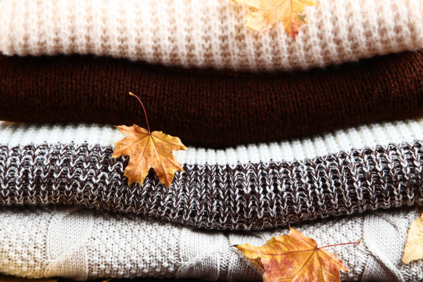 istock Background of folded sweaters with autumn leafs 1077600216