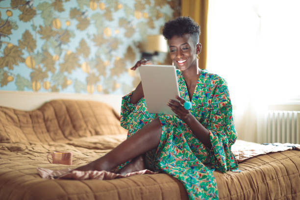 istock Young woman is browsing the internet at home 1077600748