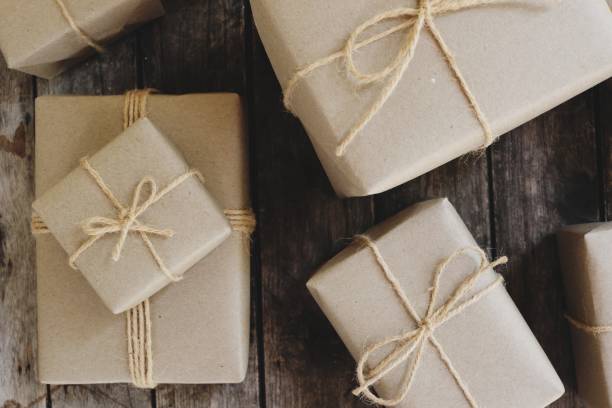 istock Eco friendly gift boxes wrapped with brown paper, green happy new year present concept, copy space 1077603322