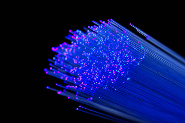 istock Fiber optics in blue, close up isolated on black background 1077605156
