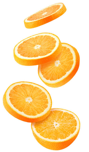 istock Isolated flying oranges. Falling sliced orange fruit isolated on white background with clipping path 1077605400