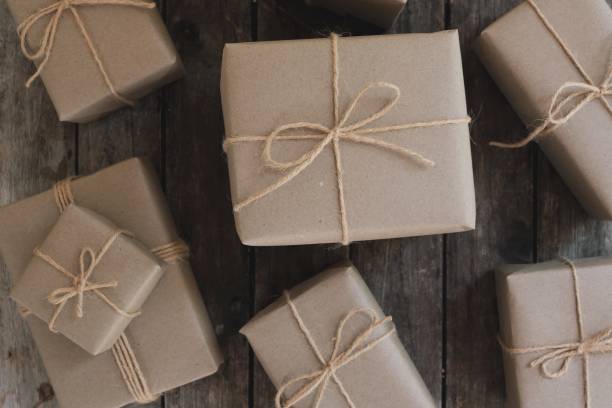 istock Eco friendly gift boxes wrapped with brown paper, green happy new year present concept, copy space 1077607168