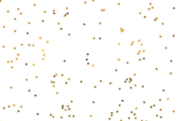 Photo of Bunch of gold stars on white background.