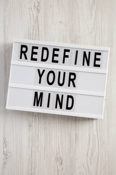 istock 'Redefine your mind' words on lightbox over white wooden surface, top view. Overhead, flat lay, from above. 1077610998