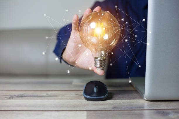 istock Business man holding light bulbs, ideas of new ideas with innovative technology and creativity. 1077615096