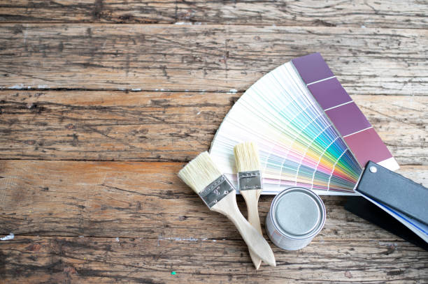 istock Painter and decorator work table with house project, color swatches and paint brushes, top view 1077616876