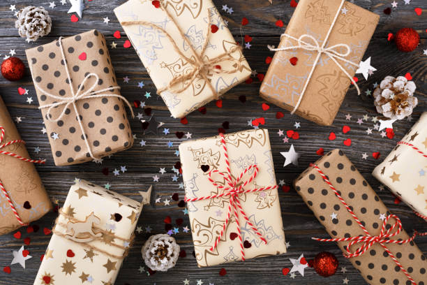 istock Christmas gift boxes & pine cones on decorated festive table with sparkle stars. 1077620272