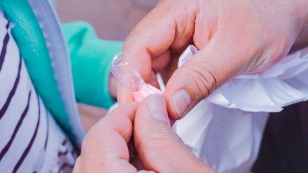 istock Men uwrapping salt water taffy candy. 1077620742