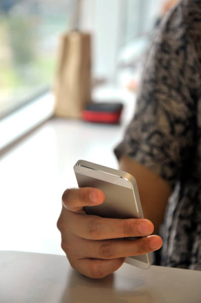istock Woman using smart phone with blank screen at table. Leisure, device. 1077620774