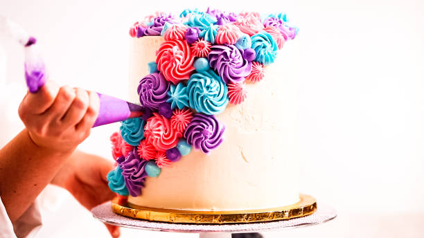 istock Baker piping pastel color buttercream rosettes 1077621160