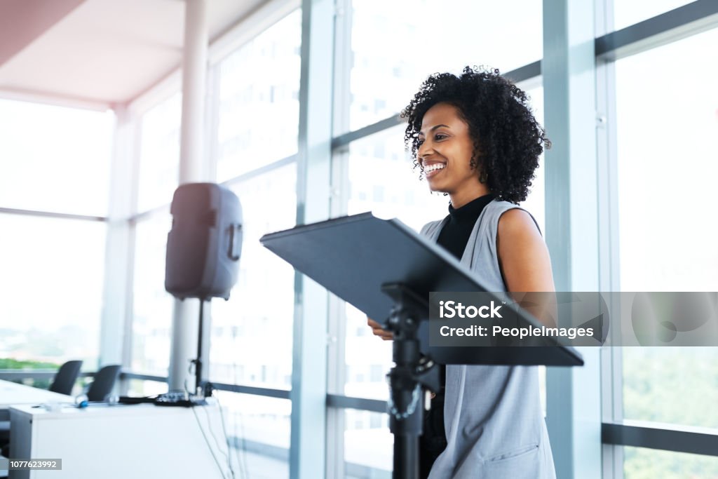 It's an honor to say a few words at this seminar Shot of a young businesswoman delivering a presentation at a conference Public Speaker Stock Photo
