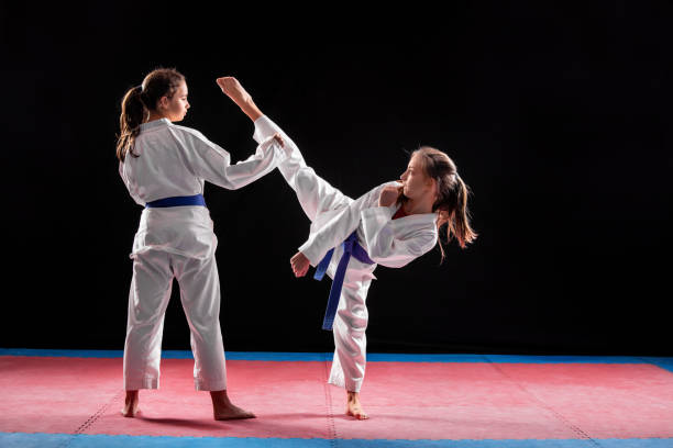 istock Two girls in taekwondo combat 1077628994