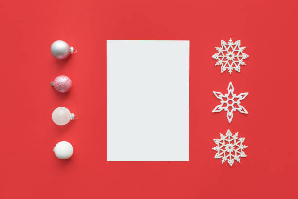 istock Christmas mockup with open white notepad, snowflakes and white silver Christmas ornaments on red background . Paper blank mock up and glass ball decorations. New year flat lay, top view, copy space, 1077630218
