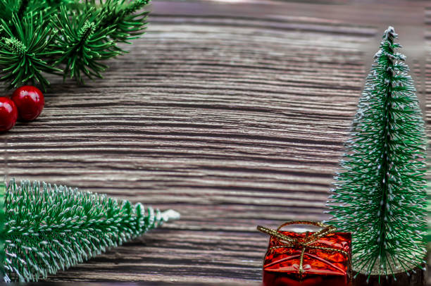 istock Christmas gift boxes under pine tree on wooden table 1077632186