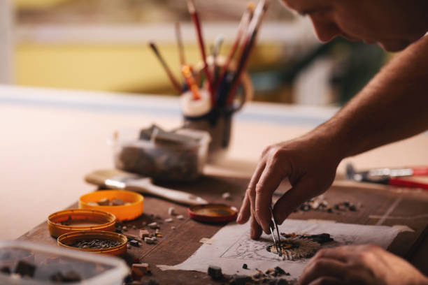 istock Closeup shots of man working on mosaic 1077635332