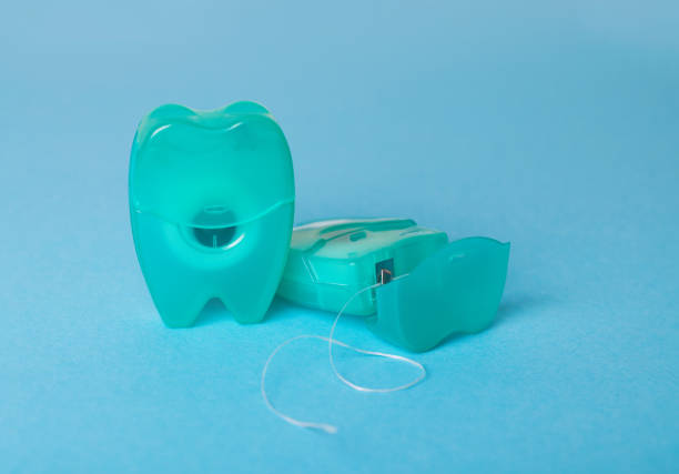 istock Dental floss on a blue background. 1077635336