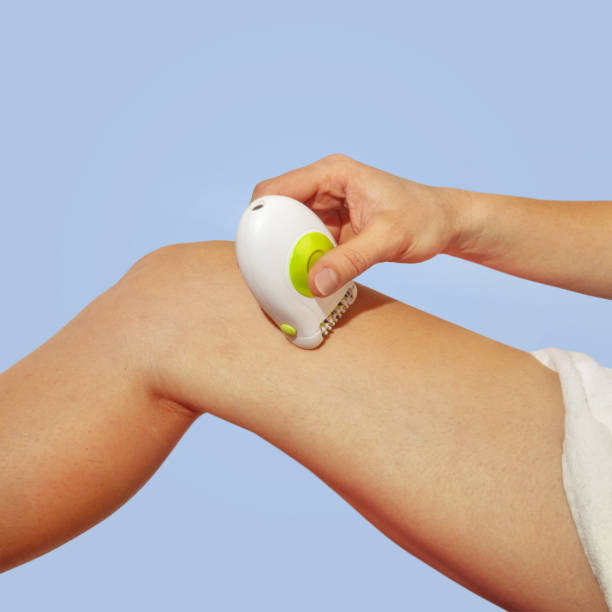 istock shaves leg by white epilator 1077639510