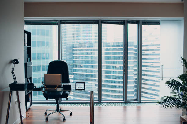 istock Modern comfortable and stylish chair, located by the window overlooking the skyscraper. 1077639604