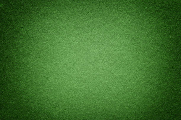 istock Texture of old green paper background, closeup. Structure of dense light olive cardboard. 1077640184