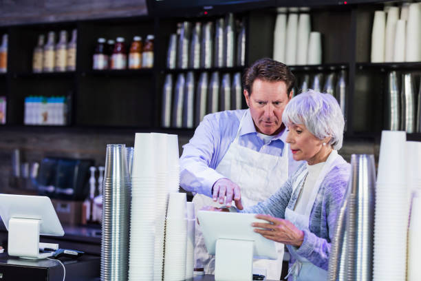istock Workers in coffee shop at cash register 1077643086